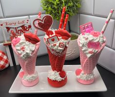 three valentine's day gifts are sitting on a plate