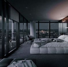 a large bed sitting in the middle of a bedroom next to a tall glass wall