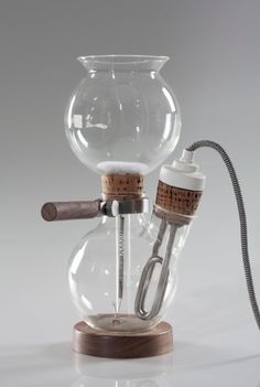 a glass bong with a wooden base and corks