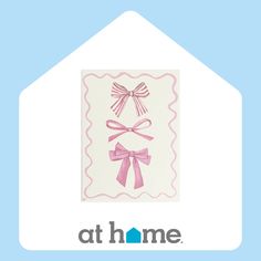 a house with a pink bow on it and the words at home written in white