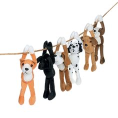 several stuffed animals hanging on a rope