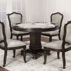 a round dining table with four chairs around it