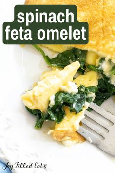 spinach and feta omelet on a white plate with a fork in it