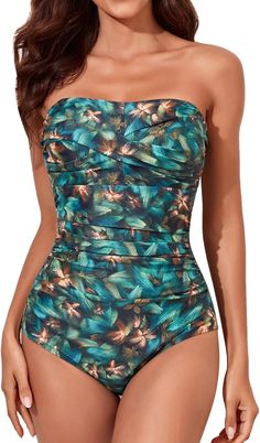 This one piece swimsuit combines fashion and function. The strapless design allows for ease and comfort while the ruched design provides a flattering fit. Padded cups offer support and enhance the natural shape. Perfect for a day at the beach or lounging by the pool. 82% Nylon, 18% Spandex The swimsuit includes double shoulder straps which help you to adjust your swimsuit, and it can also be removed. With the help of 2 different style options, you can make it either double shoulder strap swimwea Bandeau Tankini For Swimming, Tropical Strapless Swimwear, Tropical Strapless Swimwear For Swimming, Stretch Strapless Tankini For Sunbathing, Tropical Strapless Tankini For Swimming, Strapless Tropical Tankini For Swimming, Strapless Tropical Tankini For Poolside, Tropical Bandeau Tankini For Pool, Strapless Swimwear For Beach Season