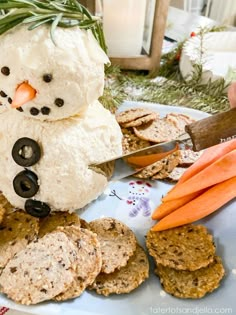 a snowman made out of crackers and carrots