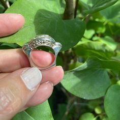 A lovely plain sterling silver ring. A highly polished rectangular plaque is mounted on beautiful scrolled wire work. The shank of the ring is sculptural and gives this ring the look and feel of another time and place. That design is 3 cm wide x 1.5 cm Only in size 6.75 and size 7 Modern Silver Hallmarked Diamond Ring, Modern Hallmarked Silver Diamond Ring, Silver Diamond Ring With Polished Finish, Unique Silver Diamond Ring With Polished Finish, Engraved Silver Dome Ring In Fine Jewelry Style, Engraved Silver Dome Ring Fine Jewelry, Silver Open Ring With Polished Finish, Silver Dome Ring For Anniversary Fine Jewelry, Silver Diamond Ring With Polished Open Ring Design