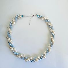 a blue and white beaded necklace with pearls