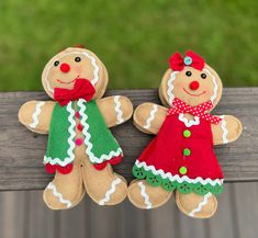 two gingerbread man and woman dolls sitting on a bench