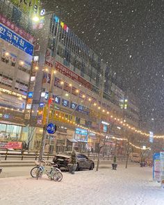 a city street covered in snow at night