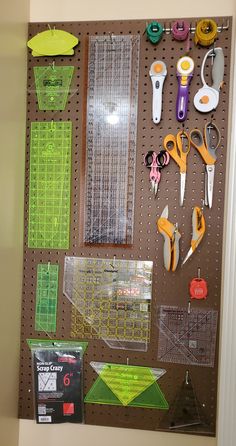 the pegboard is organized with scissors and other crafting supplies