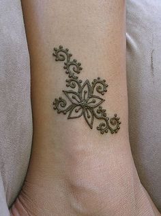 a woman's foot with a small tattoo on the side of her arm and wrist