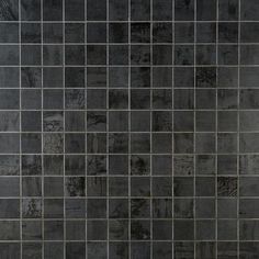 a black and white tiled wall with a toilet