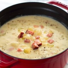 a red pot filled with soup on top of a table