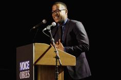 a man standing at a podium giving a speech