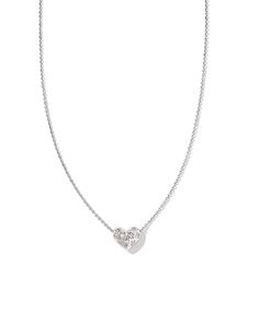 Meet the Holland Silver Heart Short Pendant Necklace in White Crystal, the epitome of understated elegance. As radiant as it is romantic, this sleek metal heart is adorned with flush-set crystals in round and marquise shapes and embellished with bright-cut decorative engravings. Styled, stacked, or gifted, this pendant Fall Flags, Silver Heart Pendant