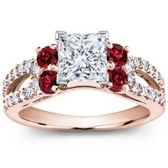 an engagement ring with red and white stones on the band, set in 18k rose gold