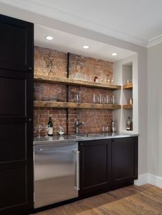 an image of a kitchen with brick wall and stainless steel dishwasher in it