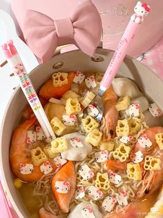 a bowl filled with noodles and hello kitty decorations