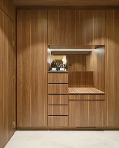 an empty room with wooden cabinets and drawers