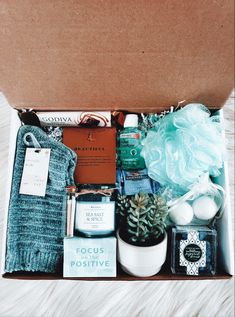 an open box with items inside on a bed