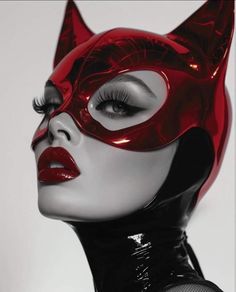 a woman wearing a red cat mask and black latex