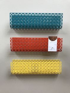 three different colored paper holders on top of each other, one has a tag attached to it