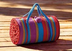 a crocheted bag sitting on top of a wooden table