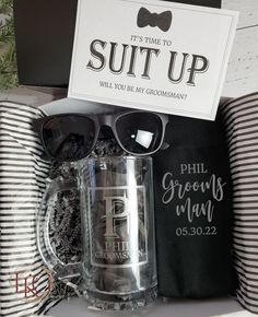 the grooms gift box includes a beer mug, sunglasses and a card that says it's time to suit up will you be my groomsman?