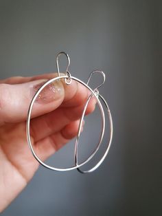 These big bold drop hoops are handmade by me using a nice thick gauge wire, so they feel substantial, yet are lightweight and comfortable to wear. I've given these a nice arch for a hint of depth. The little notch at the top ensures these always hang just so, rather than having the oval accidentally rest on its side at times. Lots of movement  with these clean, minimalist statement earrings. Entirely soldered together by my own two hands. Total length: 2 1/4in  (6cm)total width: 1 1/2in (4cm)100 Handmade Everyday Circular Earrings, Handmade Everyday Circle Earrings, Everyday Handmade Circular Earrings, Handmade Round Hoop Earrings For Everyday, Handmade Hoop Earrings For Everyday, Handmade Hoop Earrings For Everyday Wear, Handmade Everyday Hoop Earrings, Minimalist Handmade Oval Hoop Earrings, Everyday Wire Wrapped Hoop Earrings