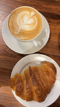 two plates with croissants and a cup of coffee