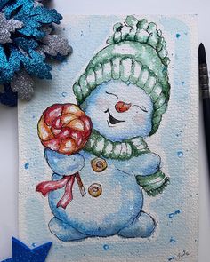 a watercolor painting of a snowman holding a candy cane