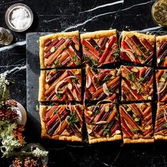 an overhead view of a pizza with many toppings on it, including carrots and radishes