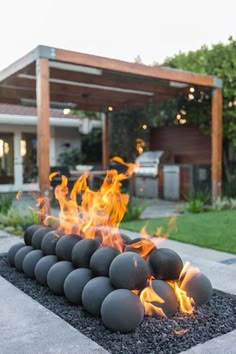 an outdoor fire pit with lots of balls on it