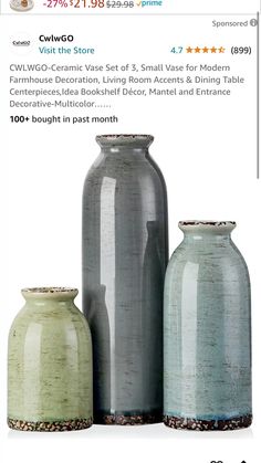 three vases sitting next to each other in front of a store advertizer