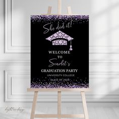 a black and purple graduation party welcome sign on an easel in front of a white wall