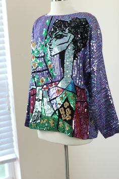 "This is so unique and such a beauty!! A fabulous unique Vintage top that is by Cassini and is from the 1980s/90s and is absolutely unique and quite rare!! Long sleeve and a top to take any outfit you have and make it wearable art!! Excellent condition! Measuring: 24\" length Dolman Sleeves: 23\" Width 44\" Pet Free/smoke free Enjoy!"