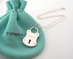 Overview:



 Here
is a gift that she will surely adore!  Offered for sale is a wonderful
Tiffany & Co. Sterling Silver & Diamonds Rectangle Locks charm necklace. Hanging
from its gorgeous Tiffany & Co 18.25 Inch Oval Link chain is a fabulous and very
pretty Rectangle Locks charm accented with 4 Super Sparkly Diamonds!   
I am 100% sure that this is one necklace that will be used a lot! 
Great conversation piece as well - in case you run out of small talk at
a cocktail party.  The Luxury Lock Jewelry For Gift, Luxury Necklaces For Gifts, Tiffany N Co, Lock Charm Necklace, Tiffany And Co Jewelry, Tiffany And Co Necklace, Padlock Necklace, Small Talk, Gift Love