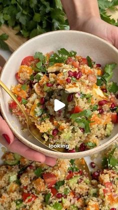 two hands are holding a bowl full of food and the video is showing how to make it