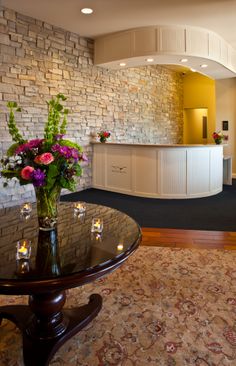 a vase filled with flowers sitting on top of a table next to a wall mounted oven