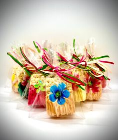 several pieces of cake wrapped in plastic and decorated with flowers