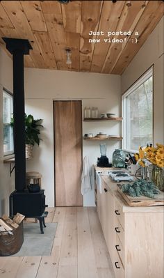 the interior of a tiny home with wood flooring and white walls, an open stove top