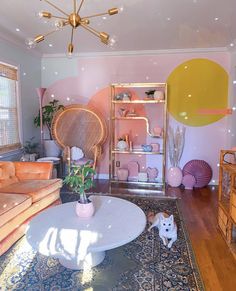 a living room filled with furniture and a cat laying on the floor next to it