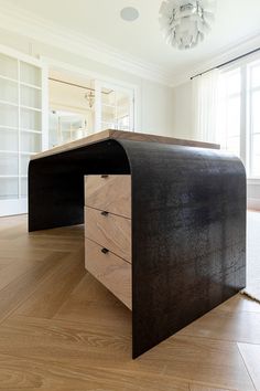 an office desk with two drawers on top of it in front of a large window