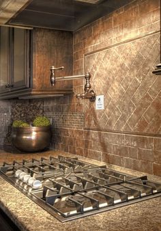 a stove top oven sitting inside of a kitchen next to a bowl of green vegetables