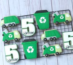 cookies decorated with green and white icing are arranged on a wire rack that says, 5