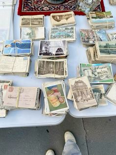 a table topped with lots of different types of cards and papers on top of it