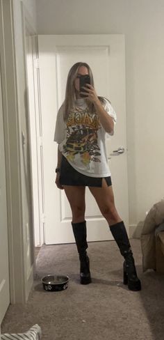 Black Mini Skirt Oversized Tee, Tshirt With Mini Skirt Outfit, Skort With Oversized Shirt, Oversized Tshirt Outfit Knee High Boots, Graphic Tee And Black Skirt Outfit, Oversized Shirt Mini Skirt Outfit, Tshirt Skirt Boots Outfit, Black Mini Skirt With Tshirt, Big T Shirt With Skirt