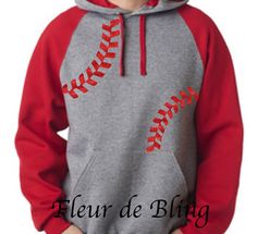 a young boy wearing a baseball hoodie