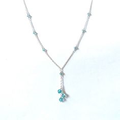 Three beautiful aqua with purple haze bicone crystals cascade down a delicate silver plated chain with matching crystal accents. Available with gold plated or gunmetal grey chain upon request. Elegant Light Blue Necklace With Beaded Chain, Elegant Light Blue Beaded Chain Jewelry, Elegant Light Blue Beaded Jewelry, Elegant Blue Dangle Crystal Necklaces, Dainty Crystal Dangle Necklaces, Silver Drop Crystal Necklace With Adjustable Chain, Delicate Crystal Chain Necklace, Silver Crystal Dangle Lariat Necklace, Silver Crystal Lariat Necklace With Dangle