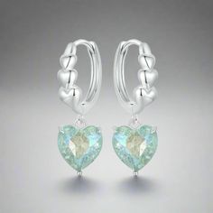 Introducing the Blue-Green Heart Dangle Hoop Earrings - crafted from 925 sterling silver, these earrings feature a charming heart dangle in a captivating blue-green shade. Here are the detailed dimensions: - Height: 23mm - Heart width: 8.5mm - Hoop inside diameter: 10.5mm These elegant earrings combine sophistication with a touch of whimsy, perfect for adding a pop of color and style to any outfit. Whether for everyday wear or special occasions, they make a lovely addition to your jewelry collection. Bridal Earrings Drop, Skull Hand, Heart Hoop Earrings, Heart Dangle Earrings, Heart Shaped Earrings, Heart Drop Earrings, Silver Colour, Birthday Jewelry Gift, Jewelry Earrings Hoops